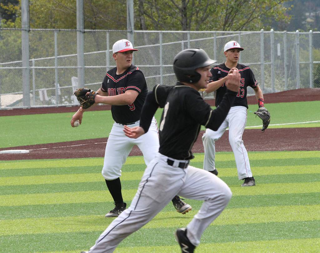 Dane Lucero fields a bunt and throws to first base for an out.(Photo by Jim Waller/Whidbey News-Times)