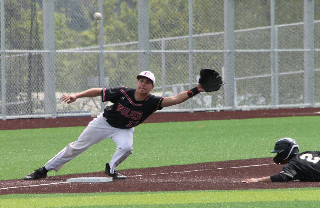 Third baseman Jake Pease reaches for a throw.(Photo by Jim Waller/Whidbey News-Times)