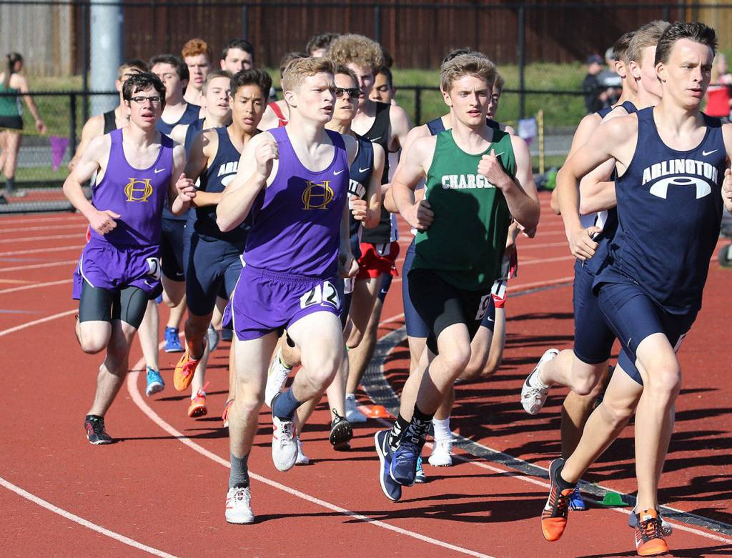 Dallas Riddle-Stevens, center (22), and Cooper Billiter, left, compete in the 1,600. Riddle-Stevens finished 11th and Billiter 20th. (Photo by John Fisken)