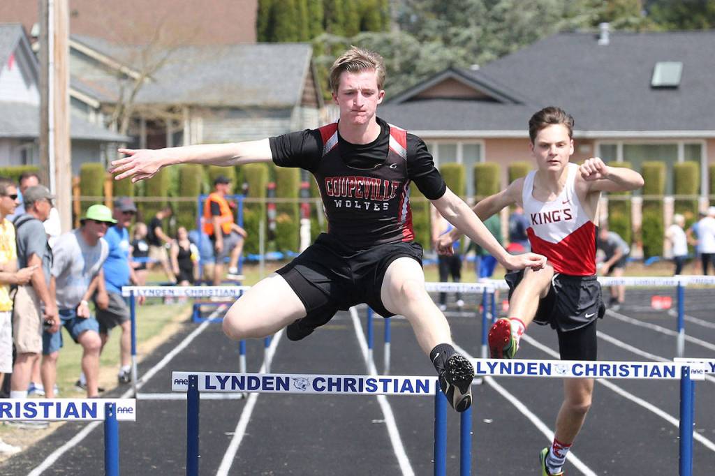 Jakobi Baumann strides over a hurdle in the 300.(Photo by John Fisken)