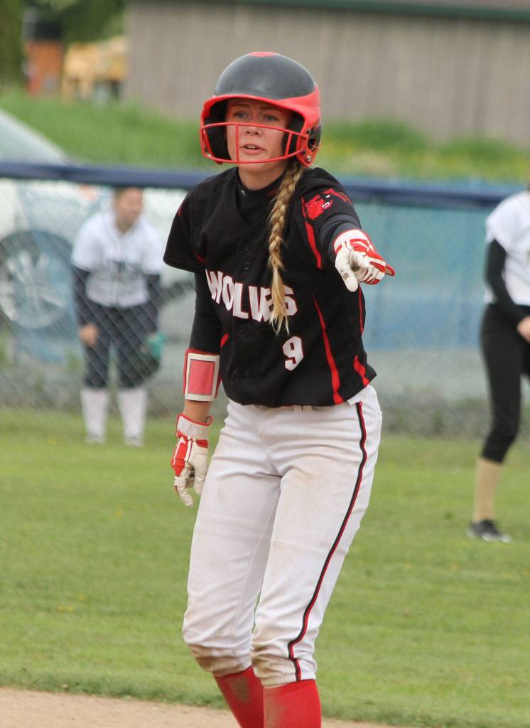Chelsea Prescott points out the hole that tripped her while she was running to second base for a double. (Photo by Jim Waller/Whidbey News-Times)