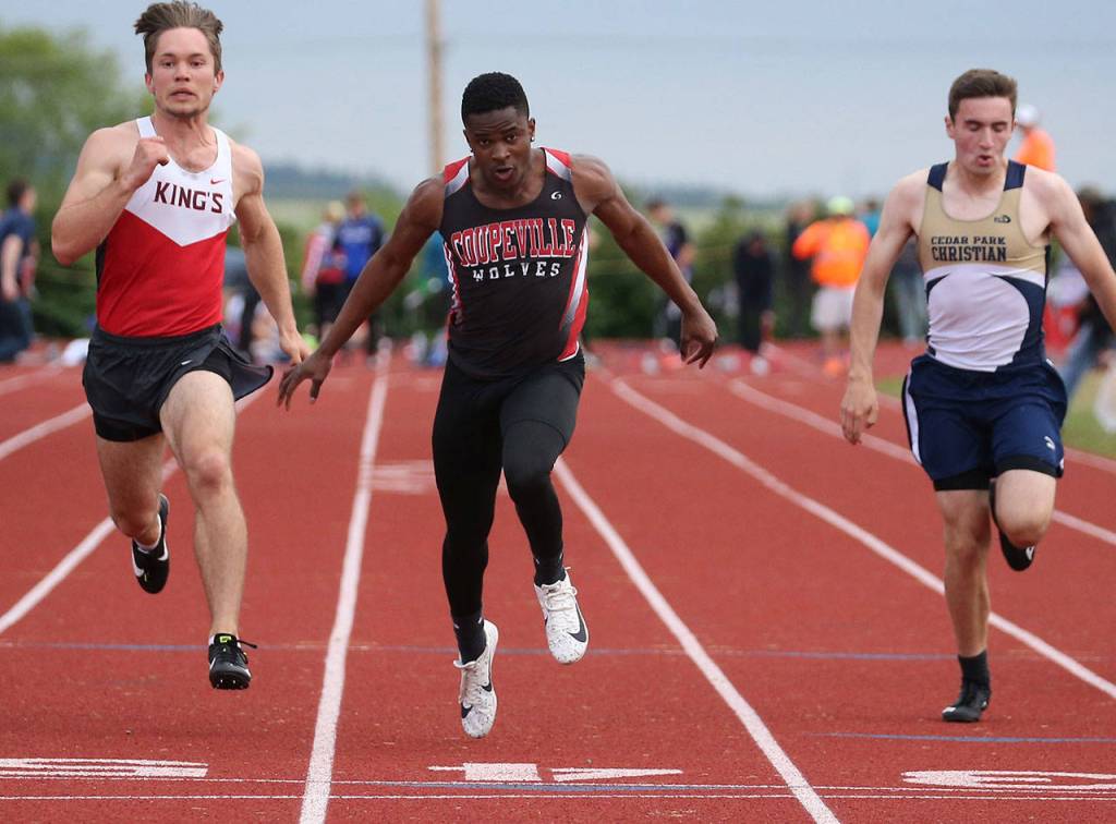 Jean Lund Olsen, center, competes in a heat of the 100 meters.(Photo by John Fisken)