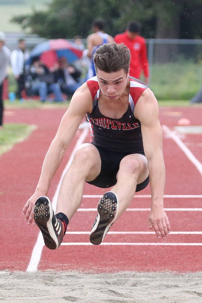 Sean Toomey-Stoat soars in the triple jump.(Photo by John Fisken)
