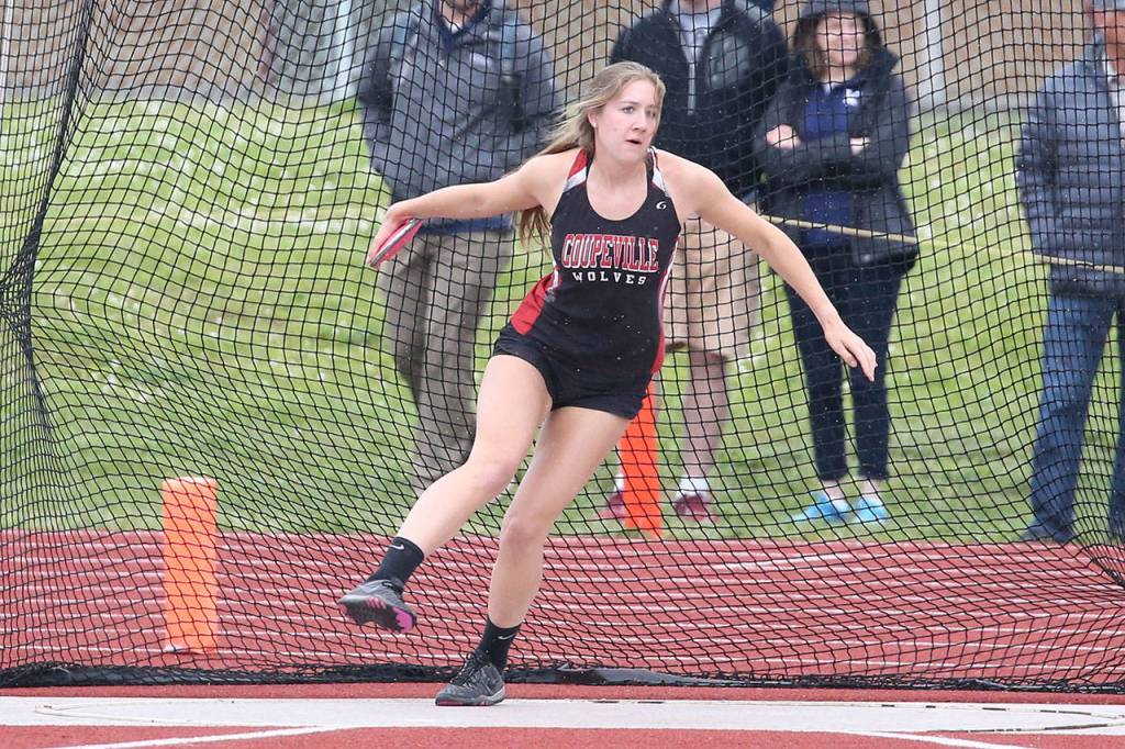 Emma Smith prepares to throw the discus. She placed fourth and qualified for the state meet. (Photo by John Fisken)
