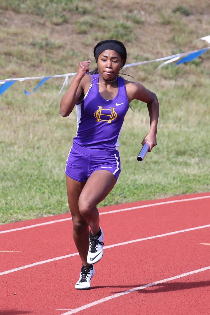 Jessica Vester runs a leg on Oak Harbors 4x200 relay team.(Photo by John Fisken)