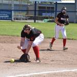 First baseman Veronica Crownover grabs a grounder as Scout Smith backs up the play.(Photo by Karen Carlson)