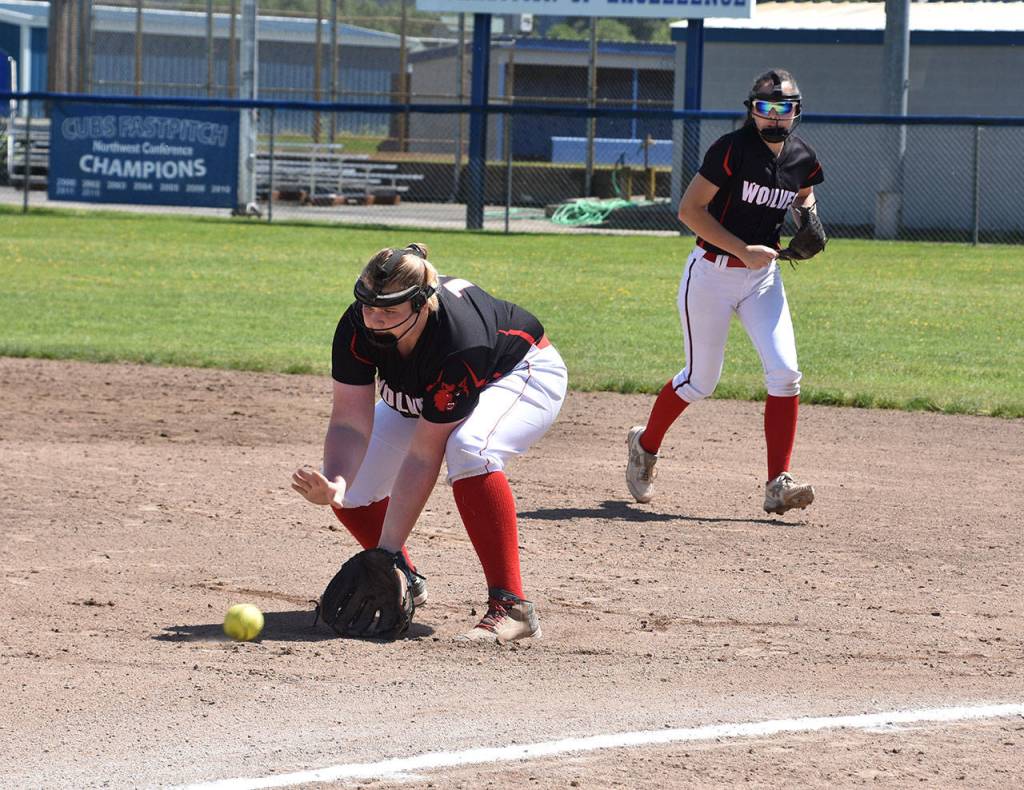 First baseman Veronica Crownover grabs a grounder as Scout Smith backs up the play.(Photo by Karen Carlson)