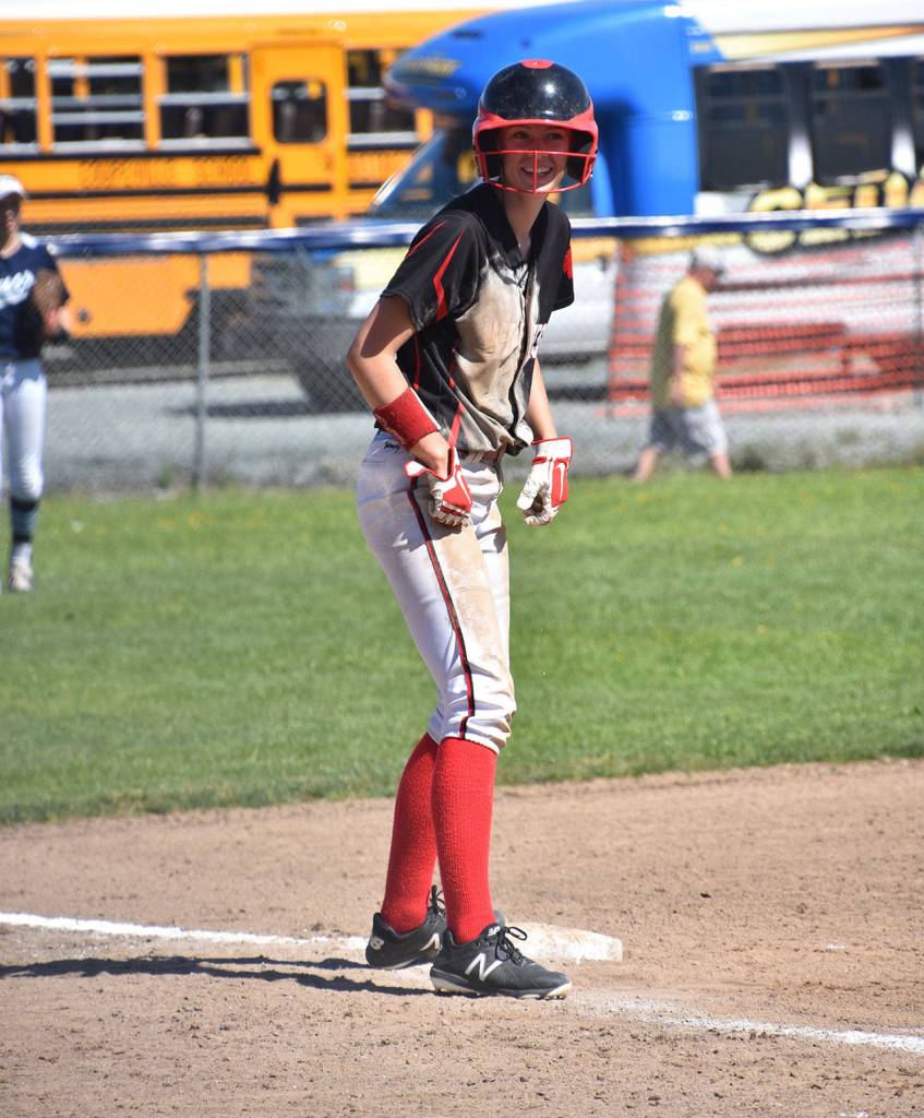 Chelsea Prescott is all smiles after a dirty landing into third base.(Photo by Karen Carlson)