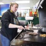Jessie Abrahamson girlls meat at A.B.s Hillbilly Gyros. She recently took over Nadyas Greek Cuisine, where she had worked as a teenager. Photo by Laura Guido/Whidbey News-Times