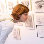 Christina Brady examines Oak Harbor Public Schools student art at a temporary gallery on Pioneer Way. Photo by Laura Guido/Whidbey News-Times
