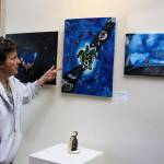 Exhibit organizer Julie Glover looks over art contributed from all of Whidbey Islands public high schools for the exhibit, Art with a Message. The annual show is at Bayview Cash Store until June 9. Photo by Patricia Guthrie/Whidbey News Group