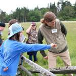 Coupeville Elementary School student Riley White asks Whidbey Camano Land Trust Stewardship Specialist Kyle Ostermick-Durkee a question during a field trip led by the land trust. Photo by Laura Guido/Whidbey News Group