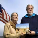 Photo submitted                                Judith Gorman and Perry McClellan hold the book compiled from the personal writings of their son Orrin, who killed himself after struggling with post-traumatic stress disorder and other injuries sustained during 2005-2006 Afghanistan combat. The former Langley couple have moved to Soap Lake where they always keep their flag at half-staff in front of their home.