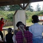 Bob McConchie demonstrates the effects of various types of bullets and firearms during a June 2 instruction session. Photo by Maria Matson/Whidbey News-Times