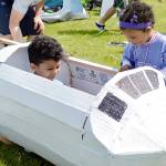 Dezmyn Ledbetter, 6, hangs out inside his home-made airplane Saturday toward the end of Relay for Life. This years theme was race for a cure; put cancer in the dust. His 3-year-old sister Gianna Ledbetter checks out the craft. Photo by Laura Guido/Whidbey News-Times