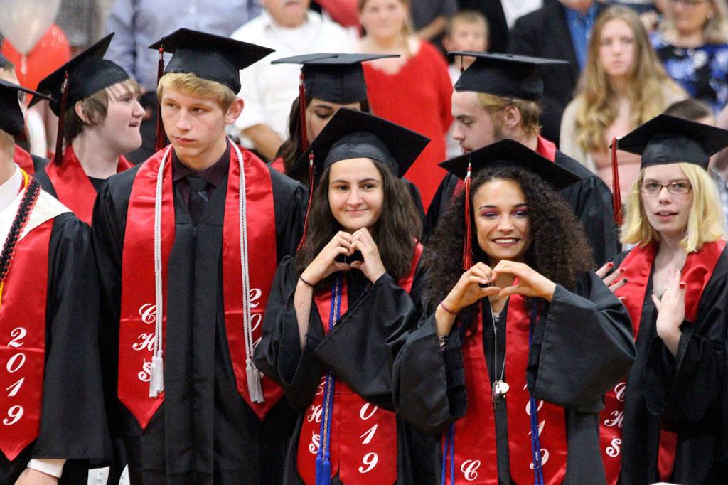 Madison Rixe, left, and Tamika Nastali make hand hearts to friends and family. Photo by Maria Matson/Whidbey News-Times