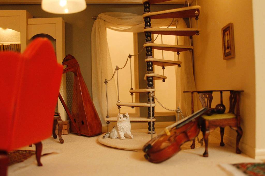 Throughout the house, there are several cats looking content.