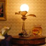 A living room table, complete with a lamp and a goldfish bowl.