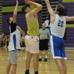 Oak Harbors Mason Myers shoots a jumper between to South Whidbey defenders in a scrimmage Wednesday. (Photo by Jim Waller/Whidbey News-Times)
