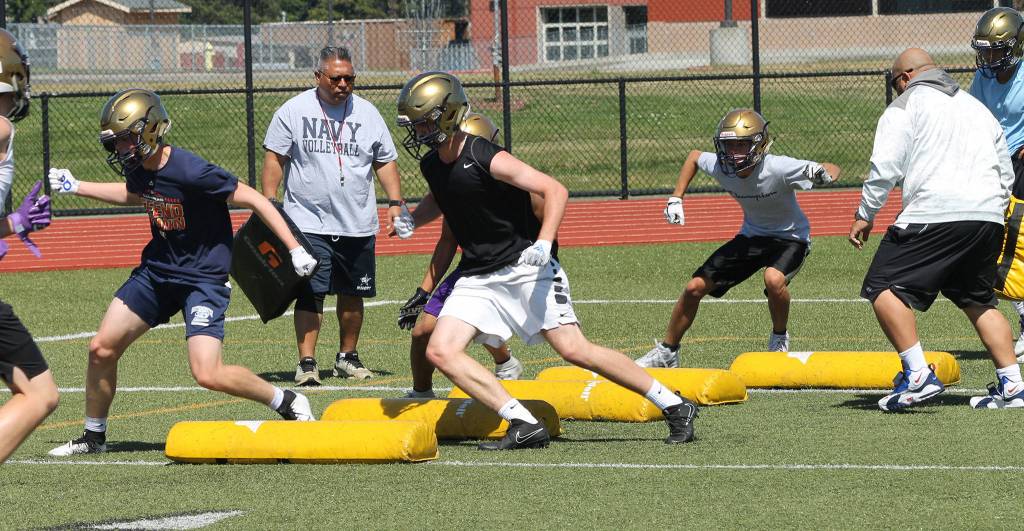 Oak Harbor football players work on their footwork during a drill Tuesday. (Photo by Jim Waller/Whidbey News-Times)