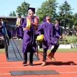 Tyler May, left, and Truth Underwood celebrate receiving their diplomas Saturday afternoon at the Oak Harbor High School graduation ceremony. Top photo, graduates toss their mortar boards in the air after Superintendent Lance Gibbon officially declared them the Oak Harbor High School graduating class of 2019. Photo by Laura Guido/Whidbey News-Times