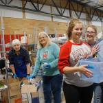 From left to right: Volunteers Linda Youngs, Susan Haworth, Ivy Leedy and MacKenzie Davis sort through donated items. Youngs and Haworth are Lions members and Leedy and Davis are members of the Coupeville Softball team.                                (Photo by Maria Matson/Whidbey News-Times)