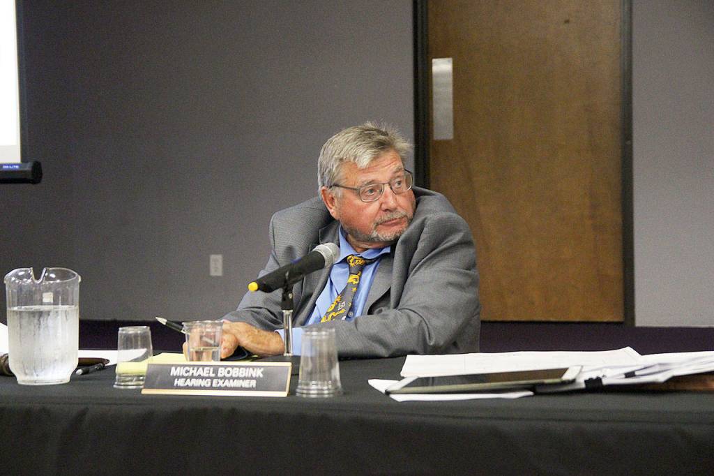 Oak Harbor Hearing Examiner Michael Bobbink listens to city staff during a meeting Tuesday to discuss a proposed affordable housing development. Photo by Laura Guido/Whidbey News-Times