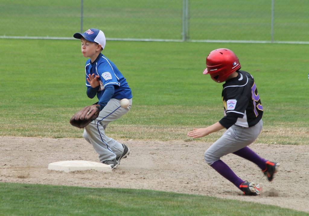 Jack Ferrell slides into second base as the ball eludes the Sedro-Woolley fielder.(Photo by Jim Waller/Whidbey News-Times)