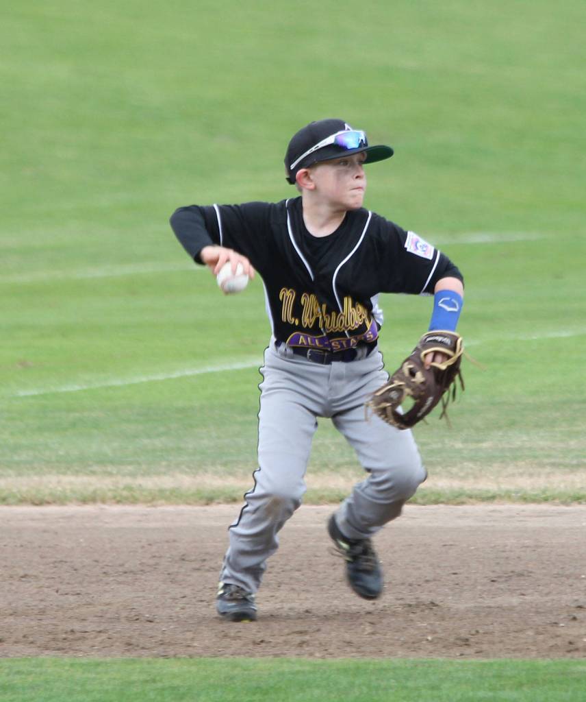 After making a diving catch, third baseman Roland Garrett jumps to his feet to throw to second to complete a double play.(Photo by Jim Waller/Whidbey News-Times)