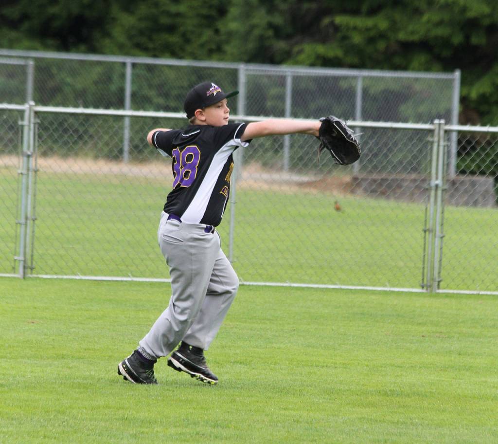 Left fielder Brayden McGhee tosses the ball back to the infield in Sundays game. (Photo by Jim Waller/Whidbey News-Times)