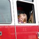Photo by Laura Guido/Whidbey News-Times                                Calleigh Bonngard, 3, pokes her head out of a Navy fire engine on display at the base open house Saturday.