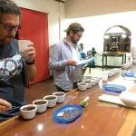 Head raoster Dennis Peseau, in the middle, tastes coffee during a recent trip to Nicaragua. (Photo submitted)
