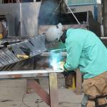 A welder does work on a high-speed passenger ferry that Nichols Brothers is building for Kitsap Transit. (Photo by Jessie Stensland / Whidbey News-Times)
