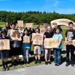 HomeConnection students proudly display the art projects the group worked on in partnership with community organizations. (Photo provided)