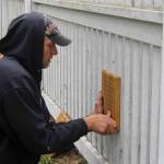 Mark Lugo of Salty Dog Woodworks installs one of the pieces of art.                                (Photo by Maria Matson/Whidbey News-Times)
