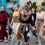 Cast members in their costumes walked in Oak Harbors Fouth of July parade with the Whidbey Playhouse float. Front row left to right: Brynn Schmid as Pumbaa, Alora Van Auken as a lioness, Jessica Turner as Rafiki and Elizabeth Löf as Sarifina. (Photo by Maria Matson/Whidbey News-Times)