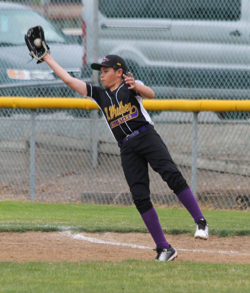 Nikko Gonzales stretches to make a catch at first base.(Photo by Jim Waller/Whidbey News-Times)