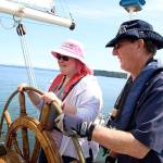 Photo by Laura Guido/Whidbey News-Times                                Dagne Shellenberg a member of Heritage Adventurers, steers the schooner Suva Wednesday under the direction of Capt. Gary McIntyre during a special sailing for the local nonprofit group.