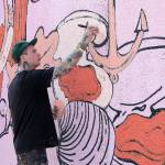 Photo by Jessie Stensland / Whidbey News-Times                                Portland artist Forest Wolf Kell works on his mural in downtown Oak Harbor.