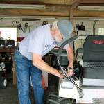 Gary Formhals tinkers with a piece of machinery at Fort Casey State Park. He is known for his handiness and fixing things around the park, which is part of the reason he received the Award for Excellence from Washington State Parks.
