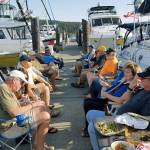 Boaters swap boating and whale tales on a beautiful day at recent dock party.