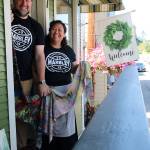 Coupeville residents and married couple Ed Hodson and Joan Samson stand in front of their new studio, Marbley. They hold a few of the many scarves theyve created.