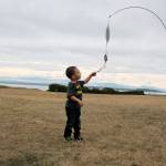 Two-year-old Alakai Dickerson of Issaquah admires an item at the ground kite display set up at the Fort Casey display on Saturday Sept. 7. Whidbey Island Kite Fliers set up the display for fun, capturing the attention of the young visitor.