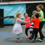 Children move to the music in front of the east end Peoples Bank Stage.                                (Photos by Maria Matson/Whidbey News-Times)