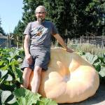 Photo by Laura Guido/Whidbey News-Times                                Ryan Nefcy leans against his sturdy Atlantic giant pumpkin, named Gertrude, which weighed in at more than 1,000 pounds. For the story, please turn to page A2 of todays Whidbey News-Times