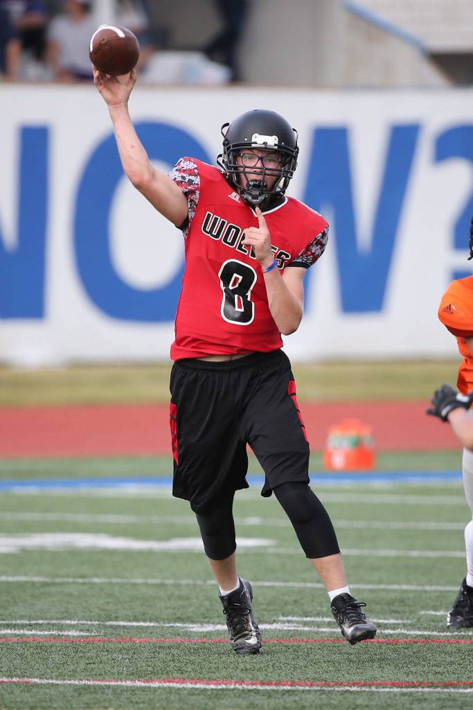 Dawson Houston tosses a pass for the Wolves. (Photo by John Fisken)