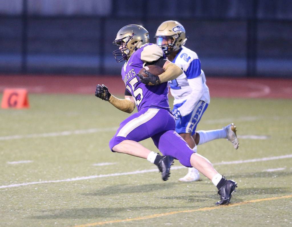 Caden Leckelt picks up some yards for the Wildcats.(Photo by John Fisken)