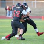 Andrew Martin (42) and Sean Toomey-Stout bring down a Port Townsend ball carrier.(Photo by John Fisken)