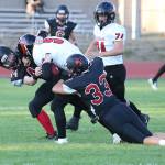 Gavin Straub (44) and Gavin Knoblich (33) stop a Port Townsend runner.(Photo by John Fisken)
