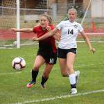 Natalie Hollrigel, left, battles for possession.(Photo by John Fisken)